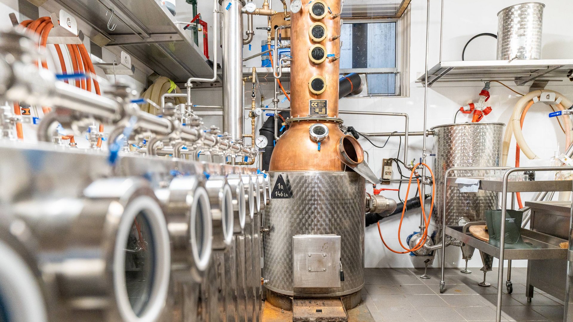The Gratznbräu brewery Distillery with distillation equipment and pipes in a room