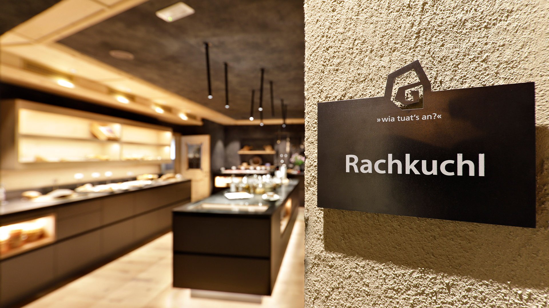 Gourmet haven Erlebnisort Gassenhof Sign with Rachkuchl text on a wall in a modern room