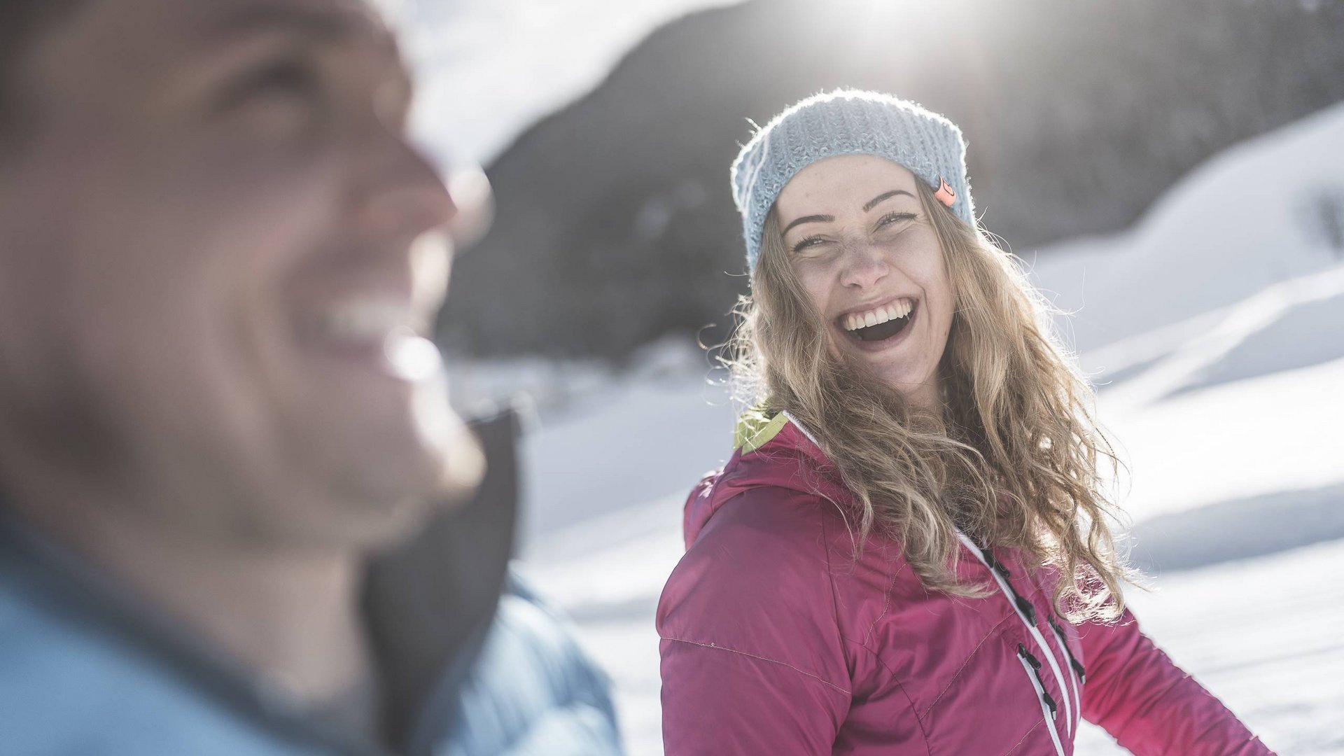 Your holiday in South Tyrol Smiling woman in winter clothes on a sunny snowy day